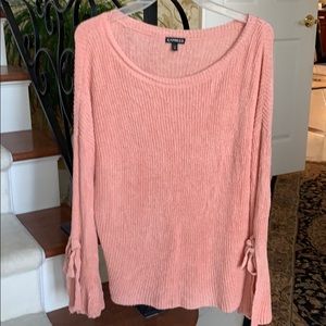Express Pink sweater with split sleeve detail.